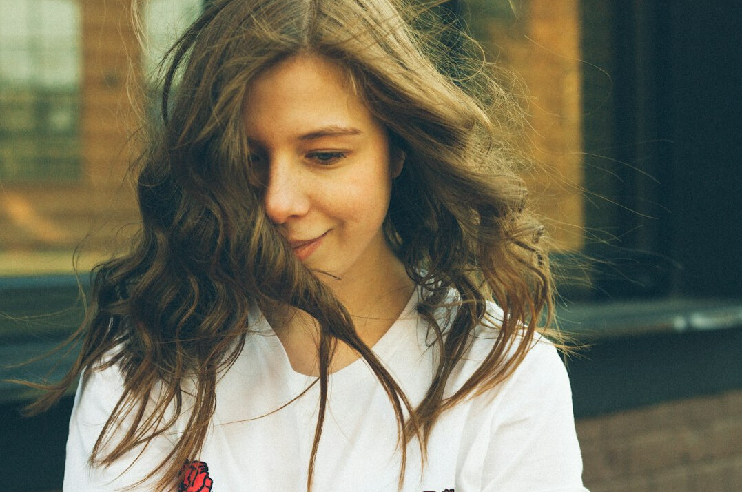 Portrait of a young woman with long hair smiling